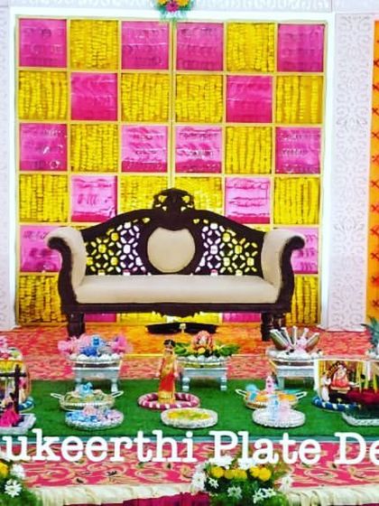 This baby shower at Kongu Mahal featured a vibrant, checkered backdrop. I used a mix of traditional and modern elements in the 15-plate grass floor setup.