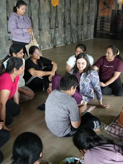 A moment of connection and conversation during a special birthday yoga event at the studio. Yoga is about building community and sharing positive energy.