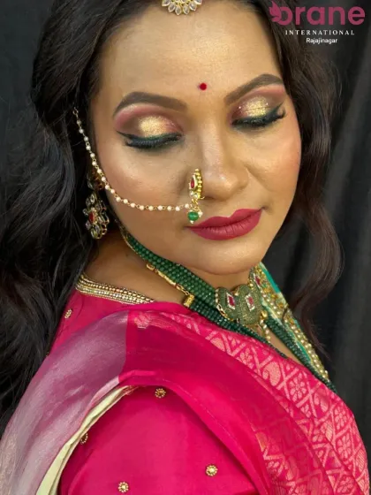 A close-up of a bridal makeup demonstration, highlighting the glitter cut-crease eye makeup and bold red lip. Our courses focus on such detailed techniques to help you create stunning and memorable bridal looks.