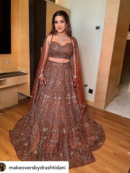 Another full-length view of this breathtaking Sangeet look. The makeup is bold enough to stand up to the sparkle of her outfit but still feels elegant.