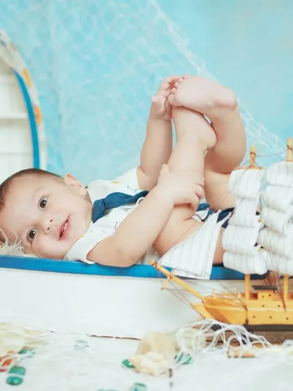 A playful pose from our sailor-themed shoot. We capture a variety of shots, from sitting and smiling to lying down and playing.