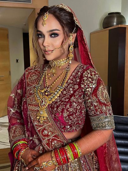 A dramatic and beautiful look for this bride, with bold smokey eyes and an intricate braided updo.