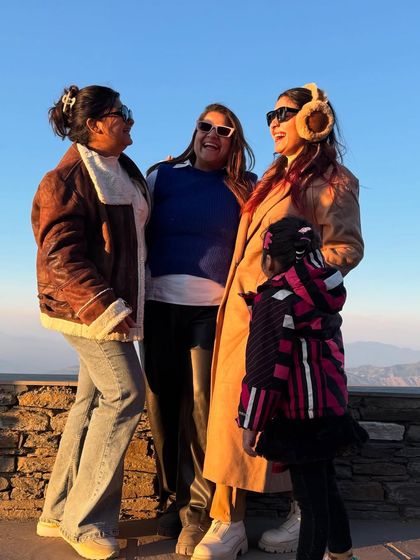 A happy moment with my family in the mountains of Mukteshwar. For this winter vacation, I layered up with a cozy trench coat and warm earmuffs.