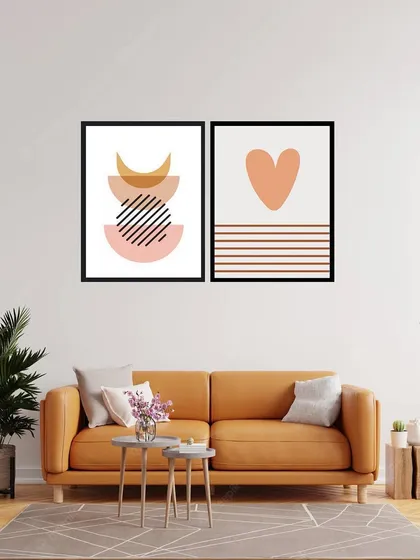 This set of two framed prints combines abstract shapes with a simple heart motif. The warm, peachy tones and clean lines create a sweet and modern art piece, perfect for a bedroom or living area.