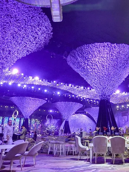 An otherworldly ambiance created with surreal, tree-like structures and dramatic purple uplighting, demonstrating our ability to execute fantastical event themes.