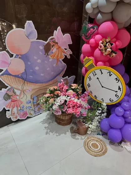 Another shot of the fairy and mushroom cutouts, paired with a prop clock and balloon clusters.