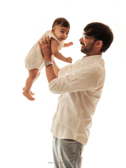 The pure joy of being lifted up by dad. These interactive shots during a milestone session are full of life and laughter.