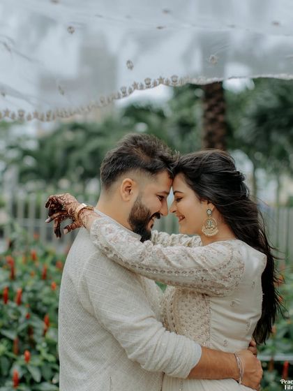 A moment of shared laughter and intimacy under a delicate veil. This pre-wedding portrait captures the couple's easy chemistry and the joy they find in each other's company.