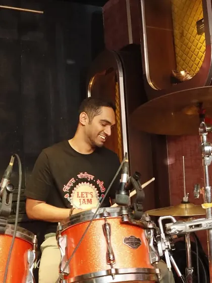 Our drummer, all smiles behind his kit. He is the heartbeat of our band, keeping the energy high all night long.