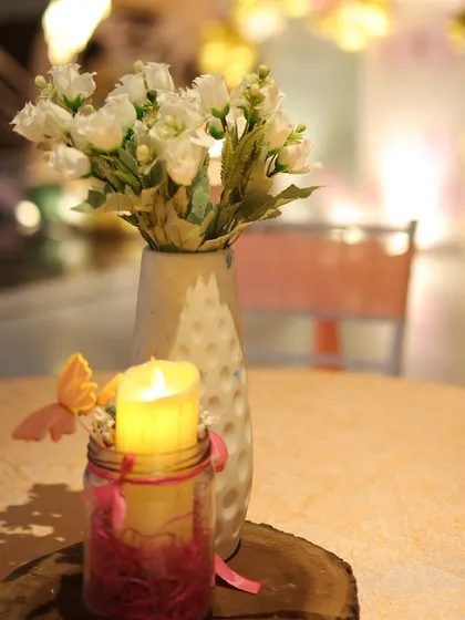 The little details matter, like this simple yet beautiful centerpiece with a candle and butterfly accent, adding to the whimsical theme.