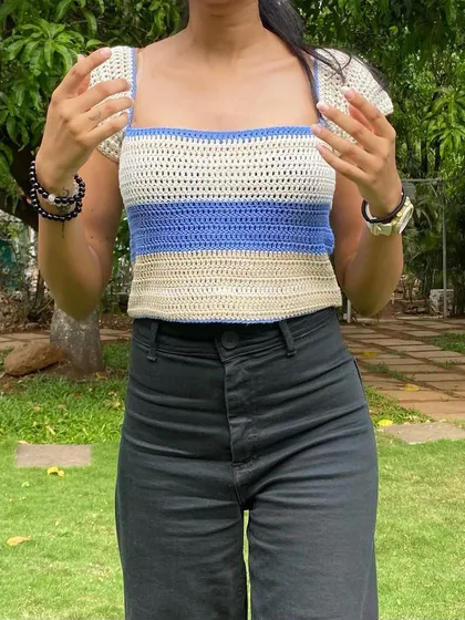 This handmade cap sleeve top is made from soft yarn, making it comfortable enough for everyday wear while still looking put-together.