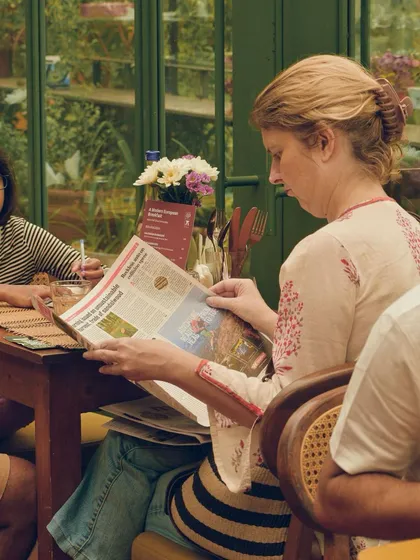 A guest leisurely reading the newspaper during our weekend breakfast event. We aim to create a relaxed and comfortable atmosphere where you can savor both the food and the moment.