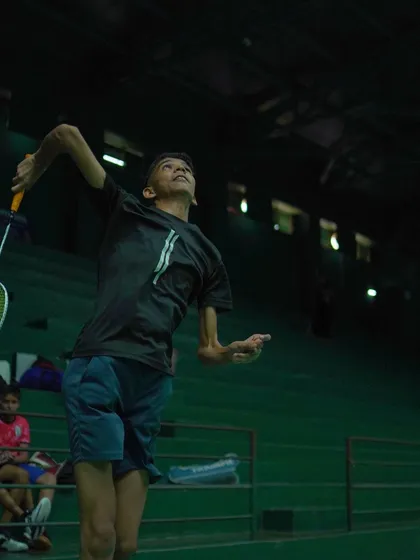 An action shot of a player executing a powerful jump smash. We capture these moments of peak performance to inspire all our athletes.