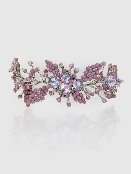 The matching purple floral bracelet, intricately woven with beads and crystals.