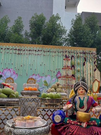 A close-up of the offering table with traditional dolls at the outdoor event.