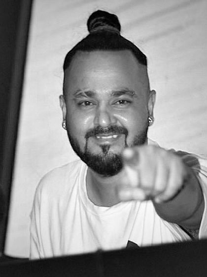 A black and white shot pointing at the camera. I see you, and I'm here to make sure you have the best night possible.