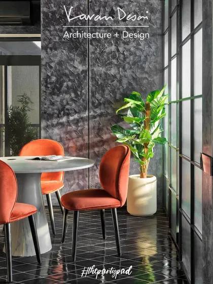 The dining area features a marble table from my Matilda Collection, paired with vibrant orange velvet chairs. The space is designed to be flexible, serving as a dining spot, a meeting table, or a serving station during parties.