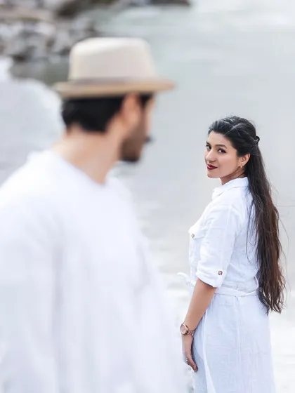 A lovely shot with a focus on her, as she looks back at him. This creates a sense of story and connection, with the river setting a serene scene.