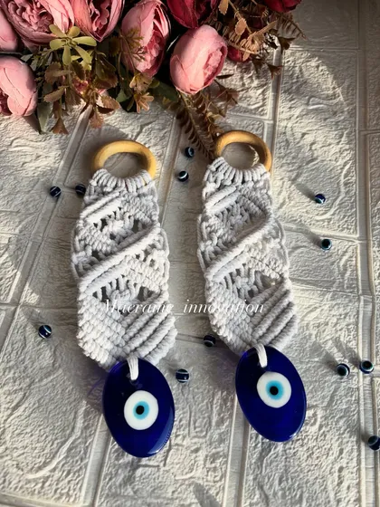 Another beautifully styled shot of the macrame evil eye hangings. The white knots contrast perfectly with the deep blue of the charm.