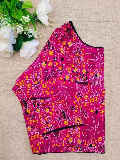 A pink cotton boatneck blouse with a vibrant, abstract traditional print.