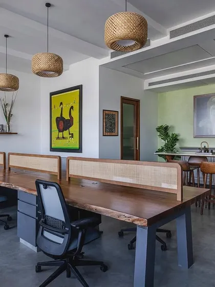 Another view of the 'Sepalika' office, showing the open layout that combines workstations with a relaxed break area, all unified by a palette of natural materials and art.