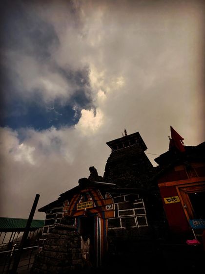 The Tungnath temple against a dramatic, cloudy sky. This shot has a very spiritual and powerful feel.