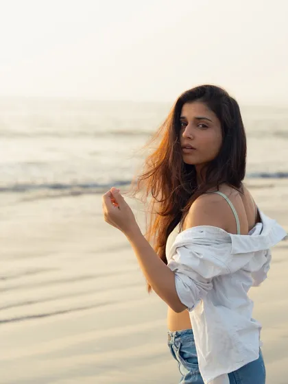 This shot has a candid, documentary feel, as if capturing a real moment of walking along the shore.