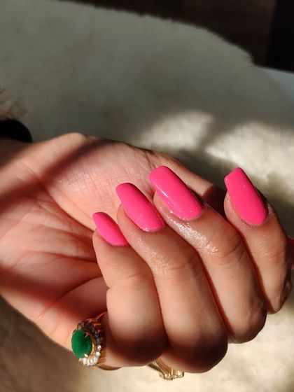 Obsessed with these vibrant pink nails. This hot pink on long, square-shaped extensions is so fun and eye-catching.