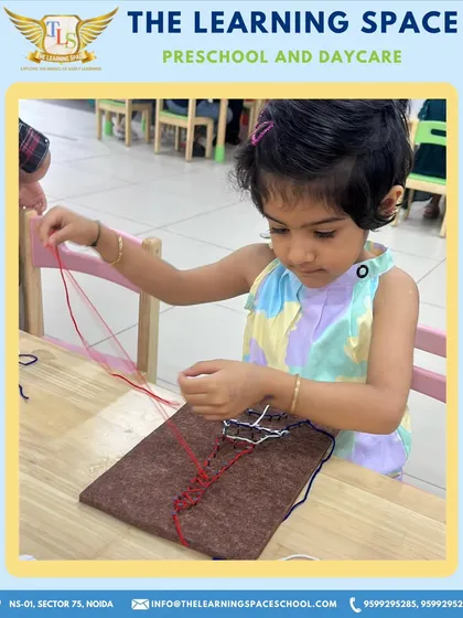 Another student meticulously works on her thread art. The focus required for this activity helps improve concentration and hand-eye coordination.