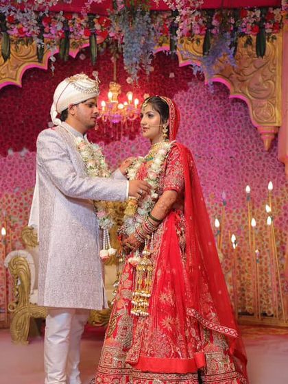 A beautiful moment from my doll's wedding day. Her classic red lehenga and our makeup look stunning in the professional photos.