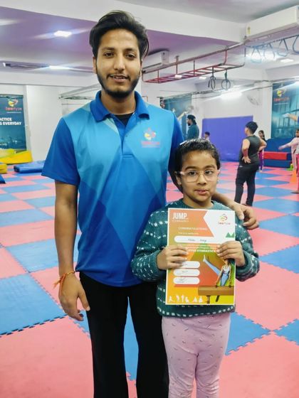 This student is excited to receive her "JUMP" program certificate.