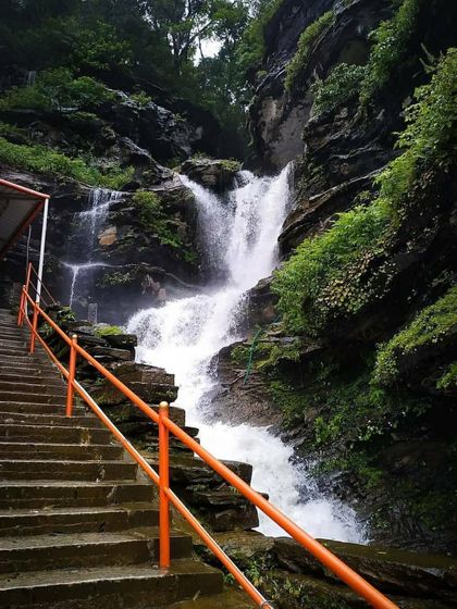 The steps leading up to the Bheemeshwara temple, with the waterfall rushing down beside them.