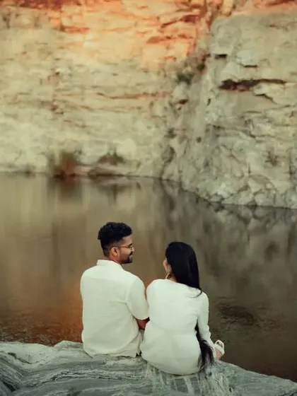 A couple enjoying the view at a quarry, with the warm light of sunset hitting the rocks. We are experienced in shooting during the golden hour to achieve that magical, moody lighting.