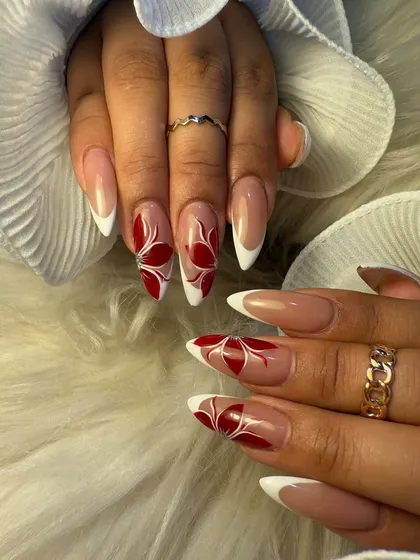 A bold and beautiful floral design for summer. We combined a classic white French tip with vibrant, hand-painted red flowers for a look that is both elegant and eye-catching.