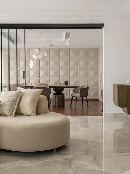This living space is a breath of fresh air, blending Japandi principles with our signature luxury. A curved sofa, fluted console, and textured wall panels come together in a calm, cozy, and effortlessly elegant composition.