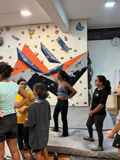 A group of climbers discussing strategy before attempting a route. Collaboration and sharing beta are a huge part of how we learn and improve together.