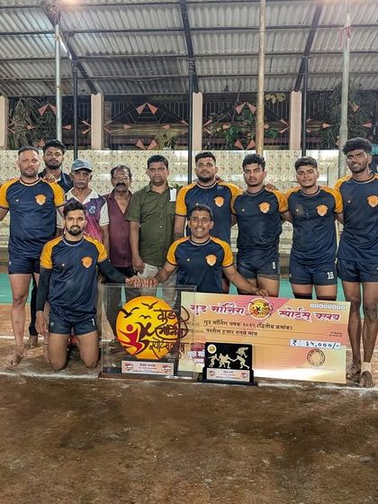 The team with the runners-up trophy, showing sportsmanship and determination.