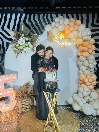 It was an honor to decorate for Lovely Star Prem and his wife's 25th anniversary. This elegant setup features a modern backdrop with a "Better Together" neon sign and a beautiful pastel balloon arch for a sophisticated celebration.
