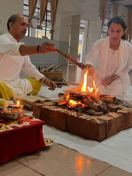 A participant makes an offering to the fire during the ceremony. It is a powerful experience of purification and setting intentions for the path ahead.