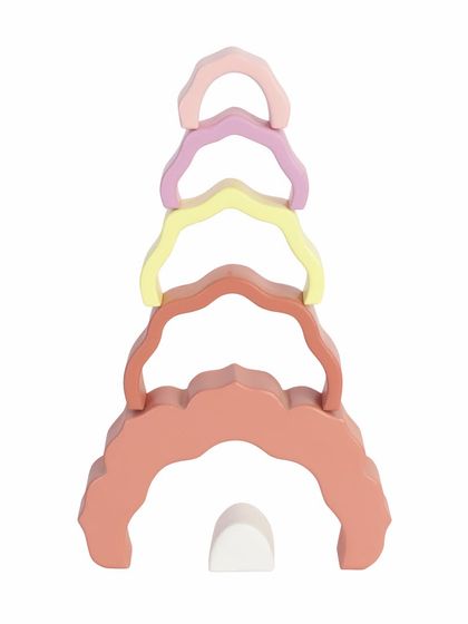 The pieces of a wooden rose arch toy stacked vertically to form a tower.