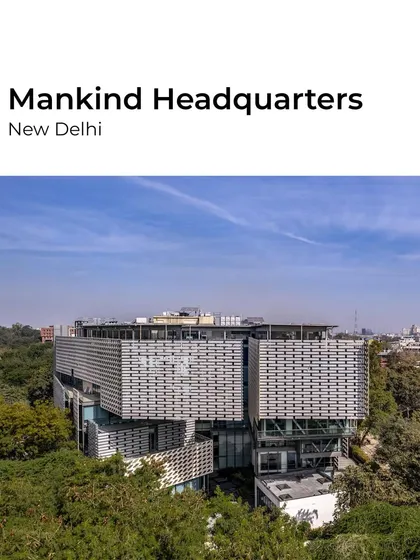 The Mankind Headquarters in New Delhi reimagines the commercial building's role in the urban fabric. The design voids the street level to allow nature in, creating a publicly accessible space that mediates between the private workspace and the city park.
