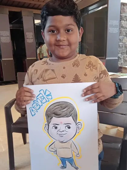 This young man, Ashank, looks very proud of his full-body caricature. I love capturing the playful energy of my younger clients.