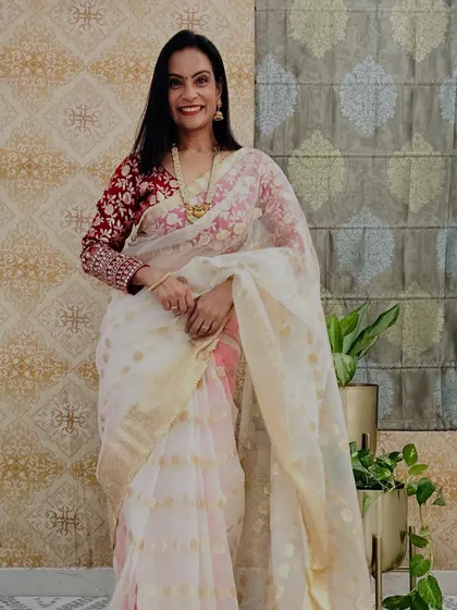 A white and gold tissue saree that looks incredibly regal. This is a perfect saree for a daytime wedding or a special puja.