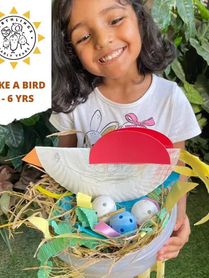 Look at that proud smile! This little one is showing off the bird and nest she created, a perfect example of our process art philosophy where the joy is in the making. This nature craft activity helps develop fine motor skills and creativity.