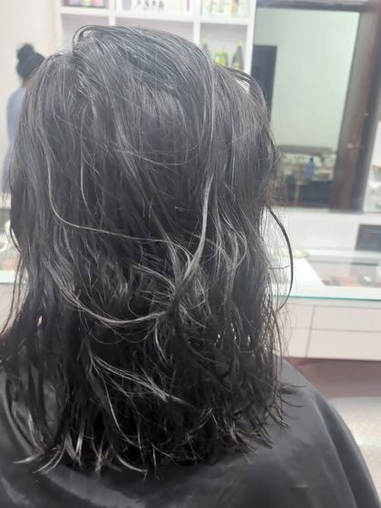 This "before" shot shows hair that is ready for a change. The client asked for smooth highlights with a Kerashine treatment to tame frizz and add gloss.