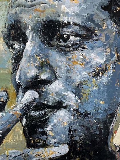 A detailed close-up of the Satyajit Ray portrait, showing the texture and layering of the paint around the eye and nose.