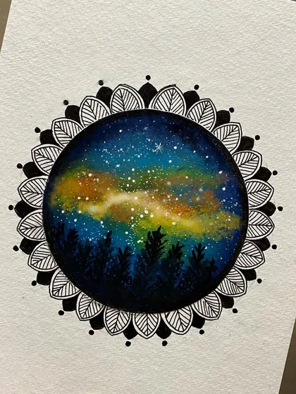 This artwork combines a painted galaxy scene with a black and white mandala border. The colorful nebula at the center is framed by the intricate leaf-like patterns of the mandala.