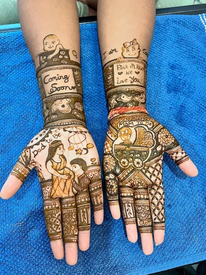 Mehendi is also for celebrating life's special moments. This custom baby shower design features portraits of the parents-to-be, a baby in a cradle, and messages like 'Coming Soon' and 'Pink or Blue, We Love You'.