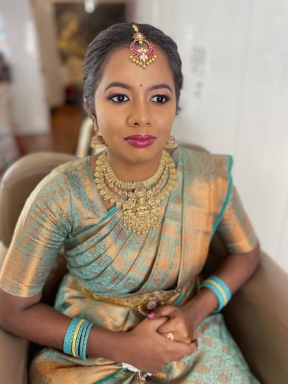 A portrait of my beautiful bride, showcasing her engagement makeup. I focused on creating a look that enhances her dusky skin tone, using a bright lipstick to complement her sea-green saree.