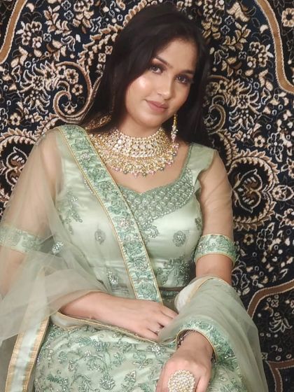 A beautiful pastel green Anarkali-style lehenga. The soft color and elegant embroidery make it a great choice for a bridesmaid or a wedding guest.